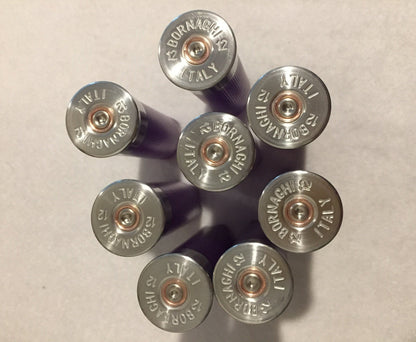 Group of silver-colored shotgun shell headstamps facing the camera