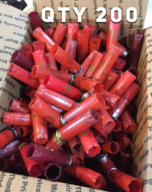 Large pile of mixed red 12 gauge empty shotgun shells in a shipping box with white overlay text reading QTY 200.