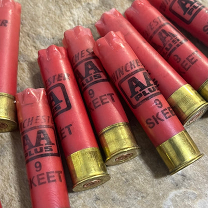 Red 28 gauge shotgun shell hulls displayed for bullet jewelry making