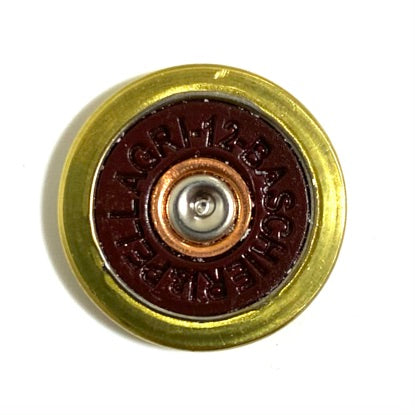 Close-up of a Baschieri and Pellagri 12 GA red shotgun shell slice with a brass rim