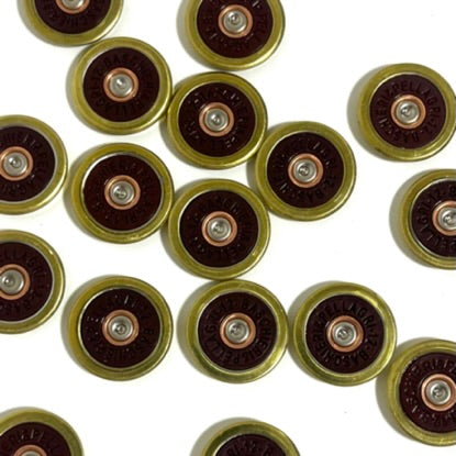 17 Baschieri and Pellagri 12 GA red shotgun shell slices with brass rims scattered on a white background