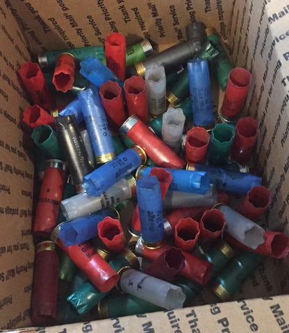 Smaller box assortment of red, blue, green, gray, and black empty 12 gauge hulls