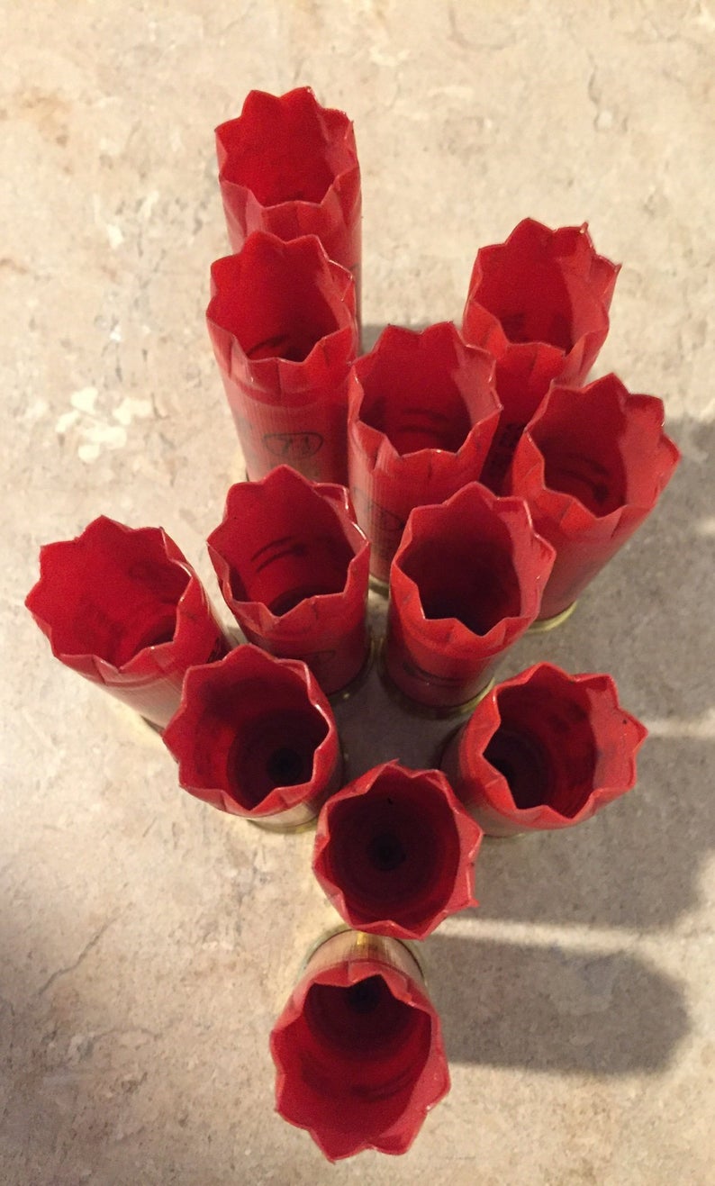 Overhead view of 10 red Clever Mirage 12 gauge shotgun shells with gold bases standing upright