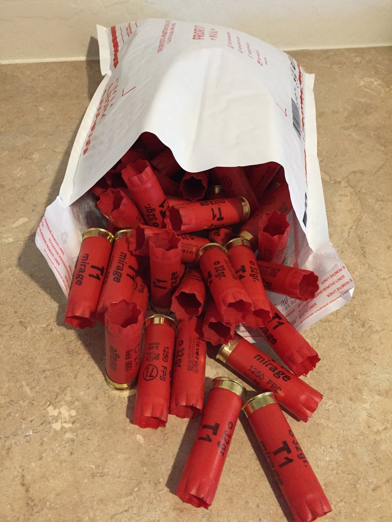 Red Clever Mirage 12 gauge shotgun shells spilling out of a shipping bag