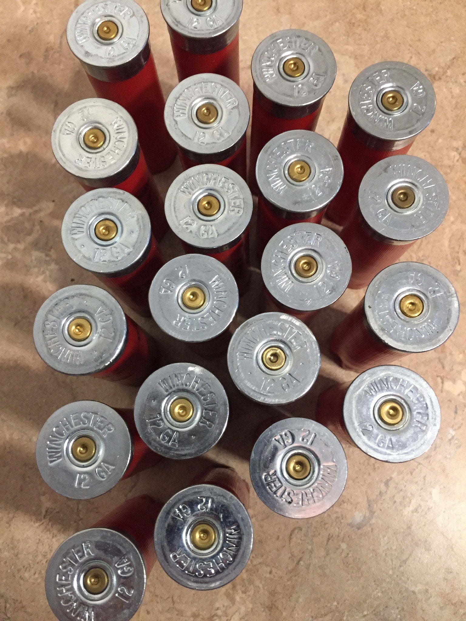 Many red Winchester 12 gauge shotgun shells viewed from above showing silver headstamps