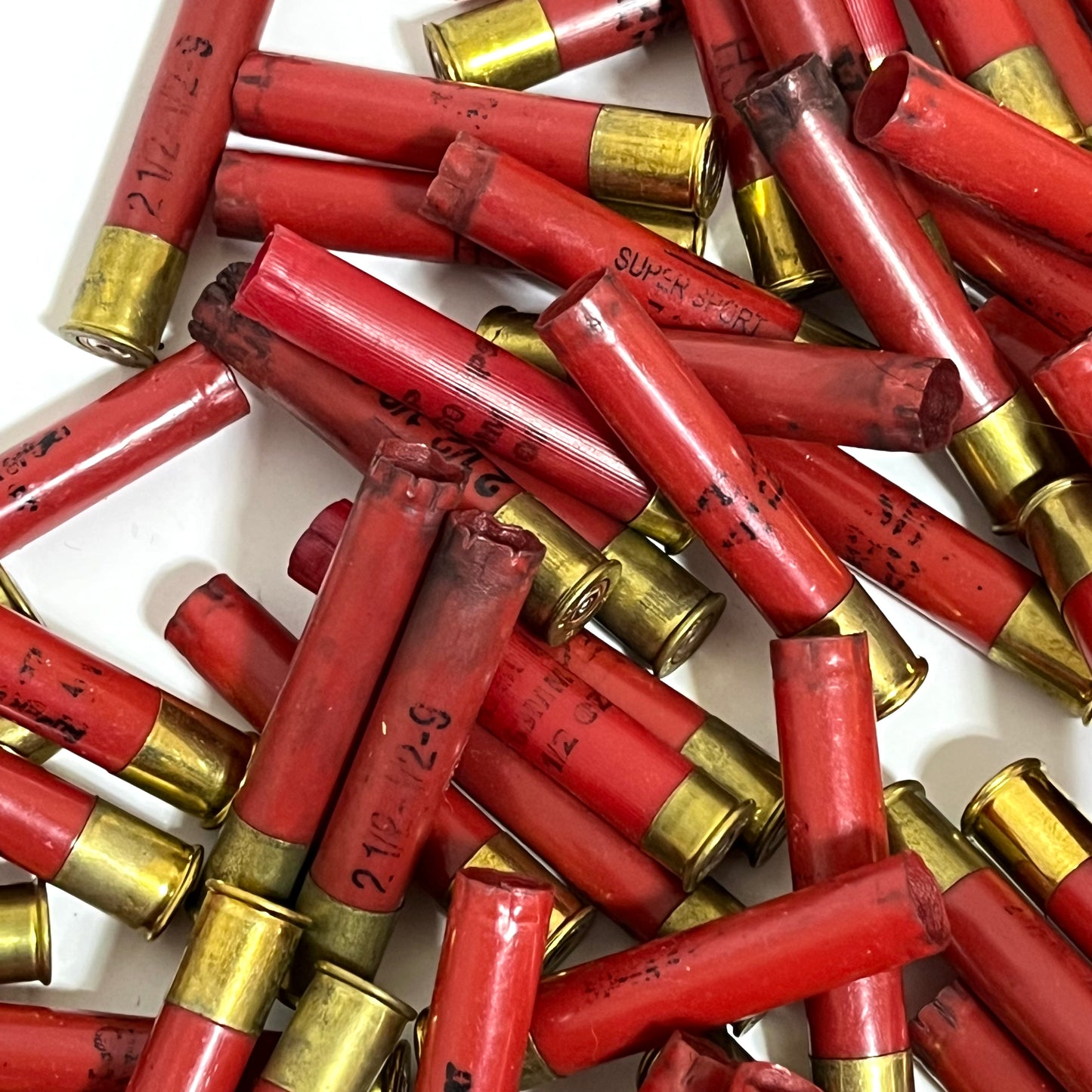 Pile of red Winchester AA 410 bore shotgun shell hulls marked Super Sport and 2 1/2-1/2-9