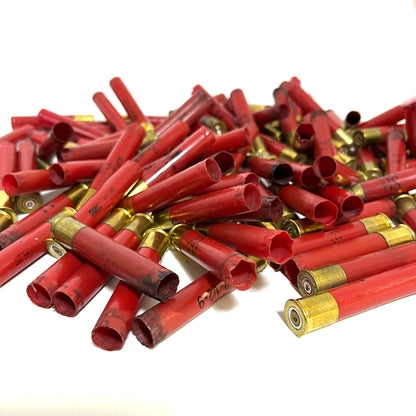 Pile of red Winchester AA 410 bore shotgun shell hulls with brass bases