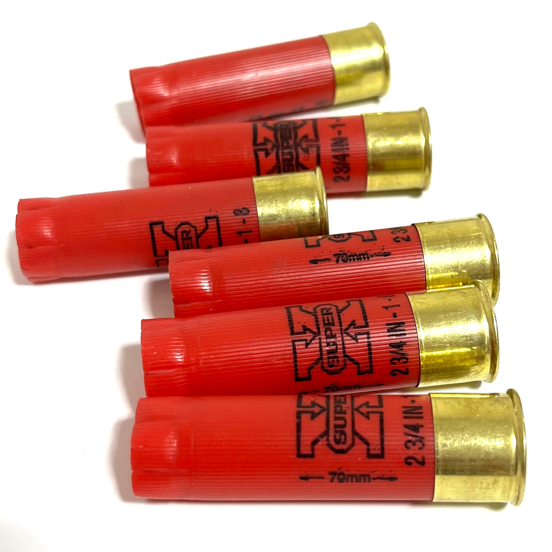 Five red Winchester Super X 16 gauge shotgun shells with brass bases lying at an angle