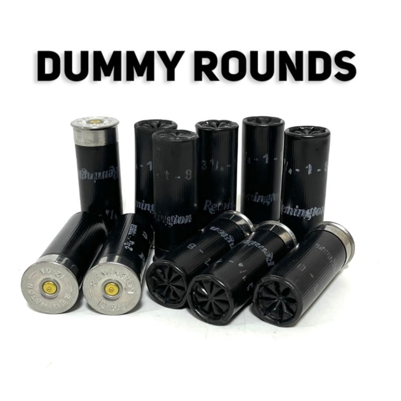 Black Remington 12 gauge once-fired dummy rounds standing and lying, crimps and silver bases out, under a Dummy Rounds title