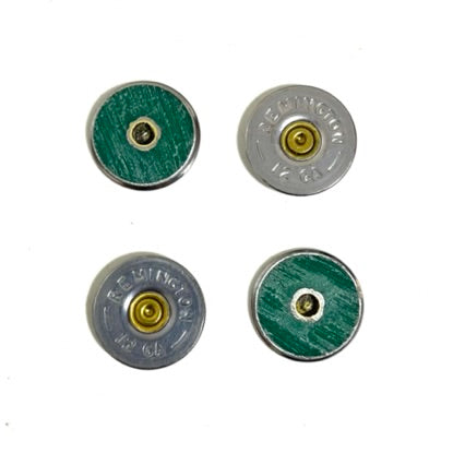 Four Remington 12 gauge shotgun shell slices arranged in a grid, alternating between the silver headstamp face and the green hull face with drilled center hole