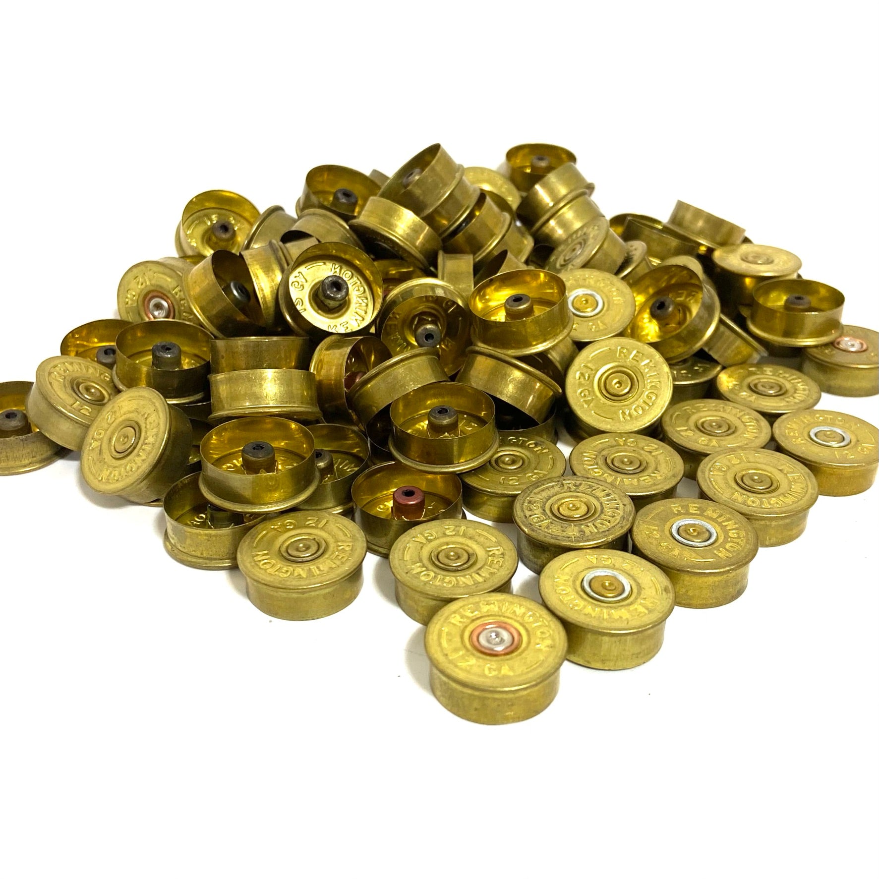 Large pile of dirty unpolished gold Remington 12 gauge shotgun shell headstamps with spent inert primers for crafting.