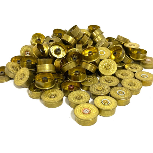 Large pile of dirty unpolished gold Remington 12 gauge shotgun shell headstamps with spent inert primers for crafting.
