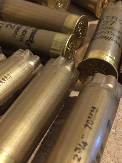 Close up view of several empty 12 gauge gold spent casings.