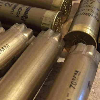 Close up view of several empty 12 gauge gold spent casings.