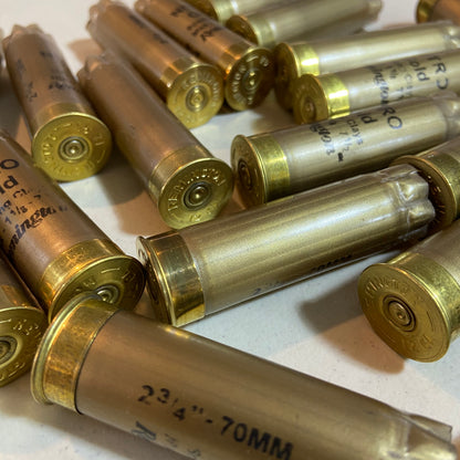 A pile of empty gold hulls showing the 2 3/4 inch markings.
