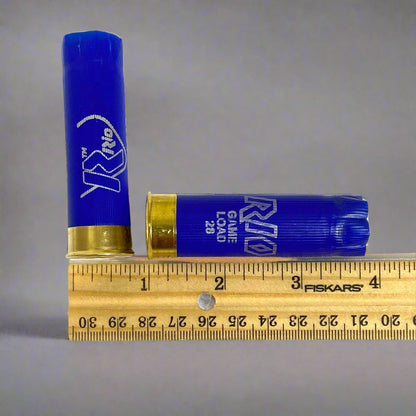 Two used RIO blue 12ga shotgun casings ruler for measurement.