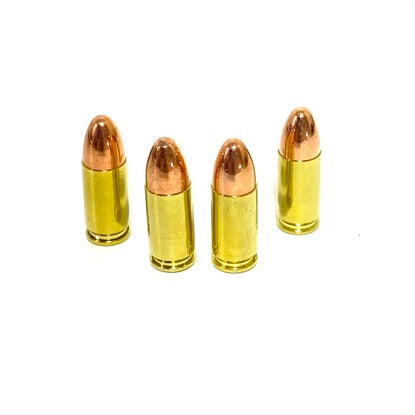 Four 9mm dummy rounds with polished once-fired brass casings and real copper round-nose bullets on white background.
