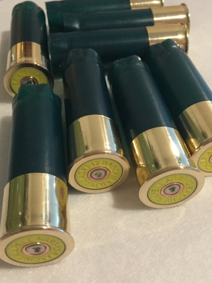 Multiple spent cartridges in green, showing golden brass bases with clear headstamps.