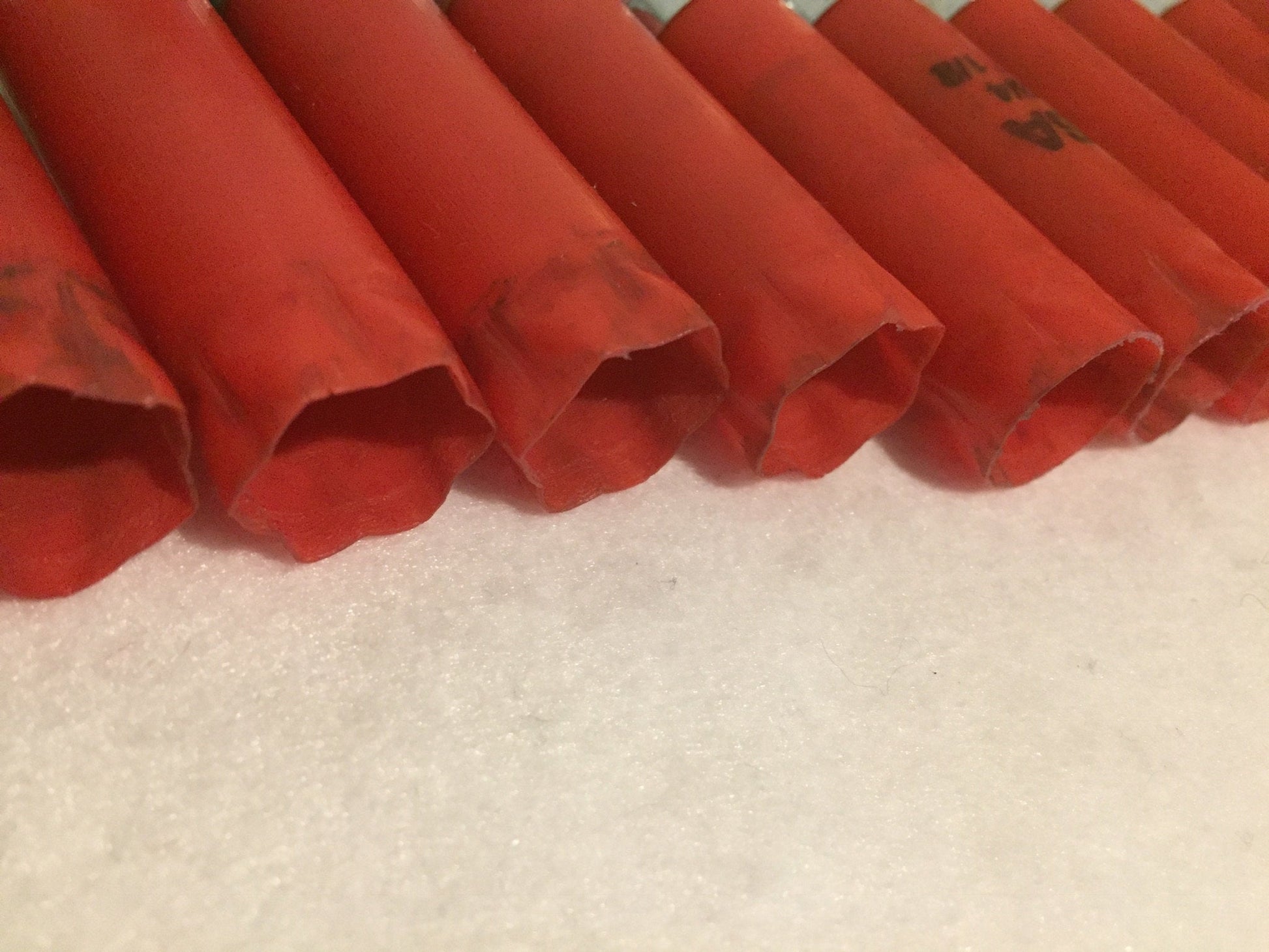 Close-up of red Winchester shotgun shells showing fluted crimped tops