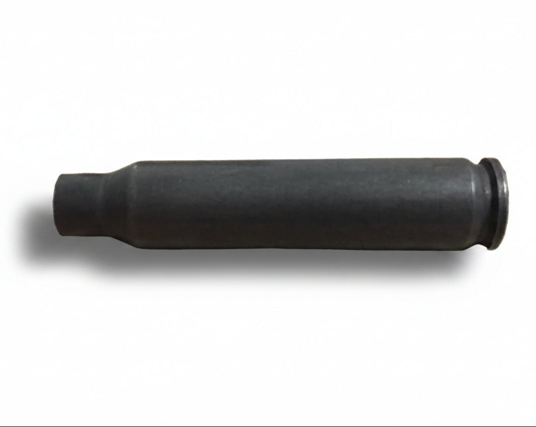 A single used gray steel cartridge lies on its side against a plain background.