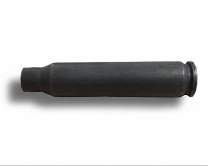 A single used gray steel cartridge lies on its side against a plain background.