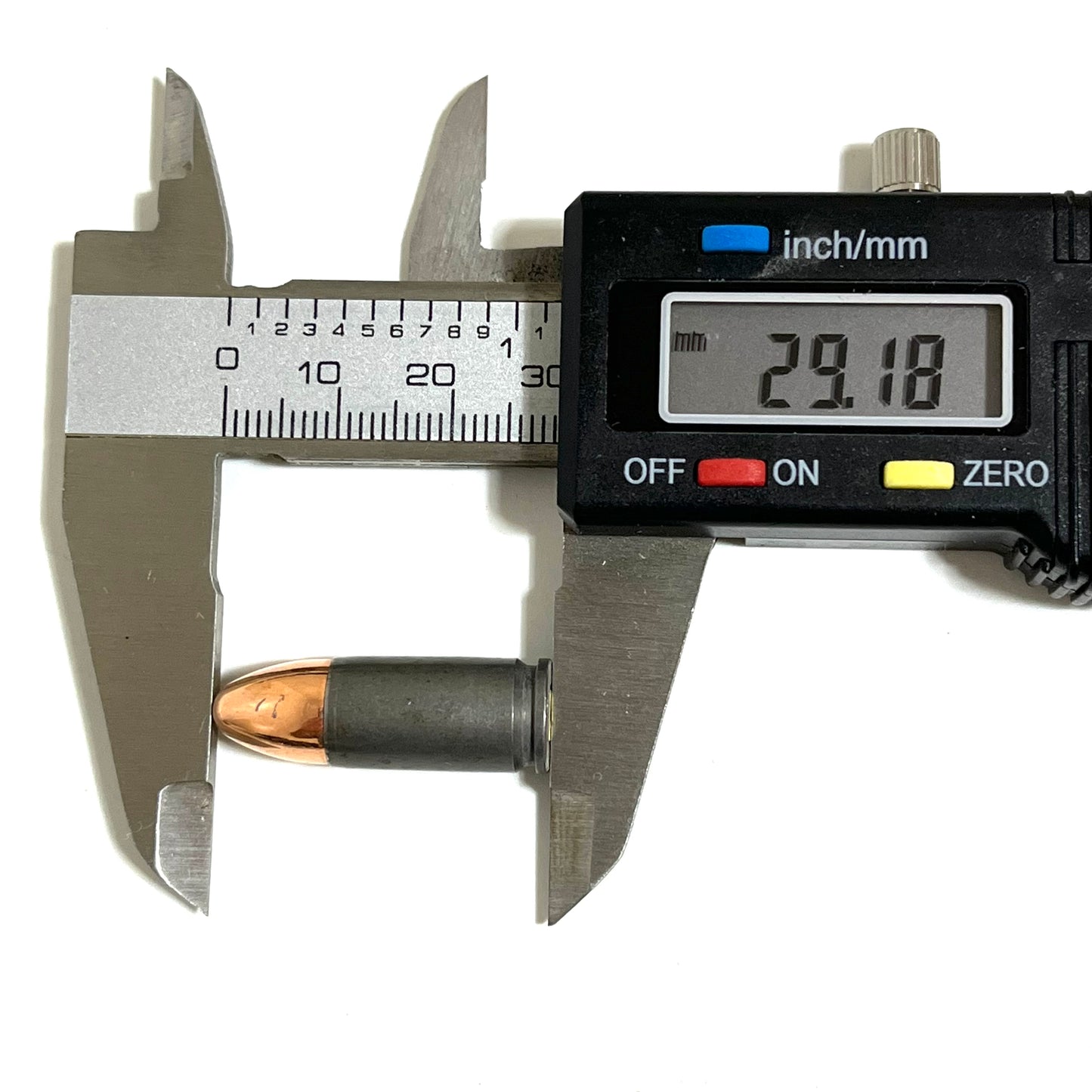 A single gray steel 9mm dummy casing with bullet, measured lengthwise reading 29.18 mm