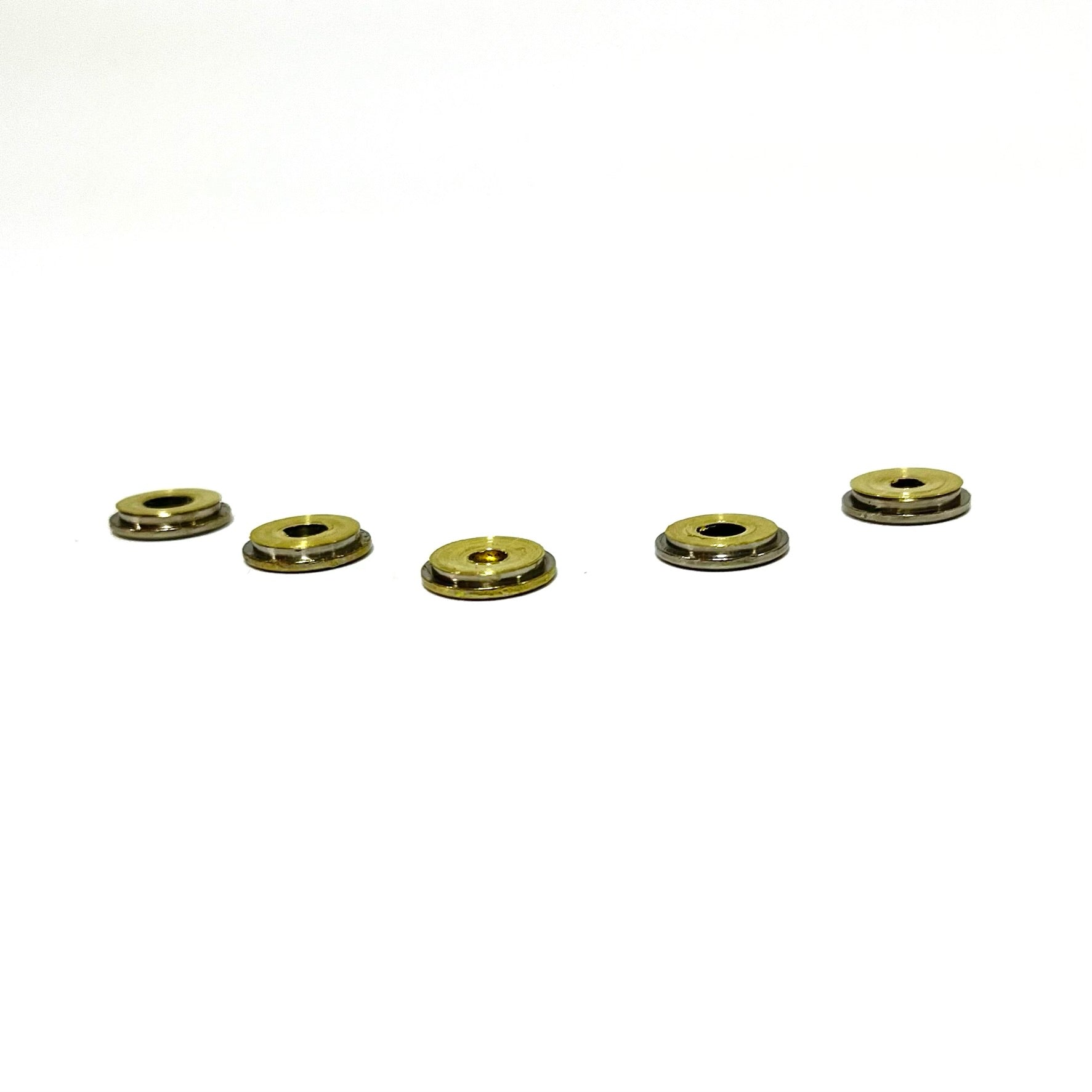 Five thin cut bullet slices displayed in a row showing a side view on a bright white background.