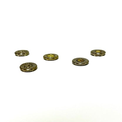 Five thin cut bullet slices shown from a side angle to illustrate their thickness on a white background.