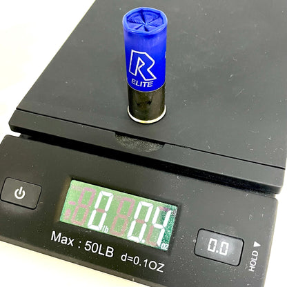 A single rio dummy shotgun shells on a digital scale showing 0.4 oz.