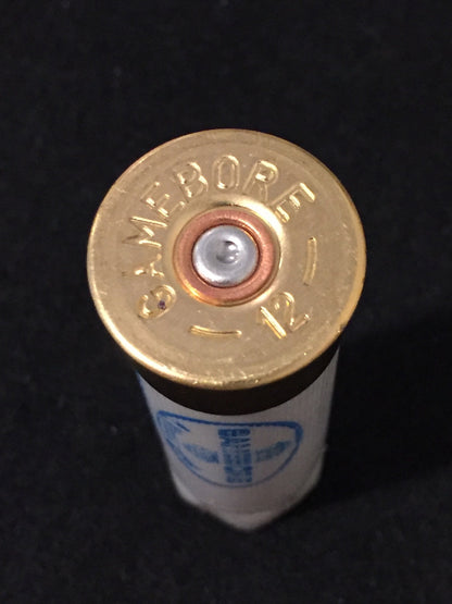 Close-up of a gold brass shell head embossed "Gamebore 12" with a white shell body below