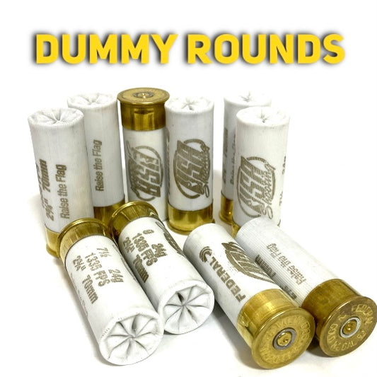 White once-fired dummy rounds with gold brass bases, some upright and some lying, showing Federal headstamps on a white background.
