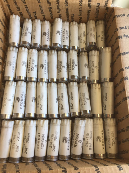 Rows of white Federal Top Gun shotgun shells packed inside a Priority Mail shipping box