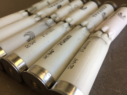 Row of white Federal Top Gun shotgun shells lying down showing 2 3/4 inch 70mm markings and silver bottoms