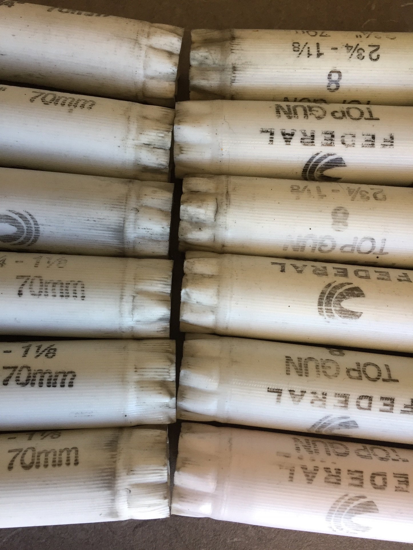 Two rows of white Federal Top Gun shotgun shells showing 2 3/4 - 1 1/8 70mm markings