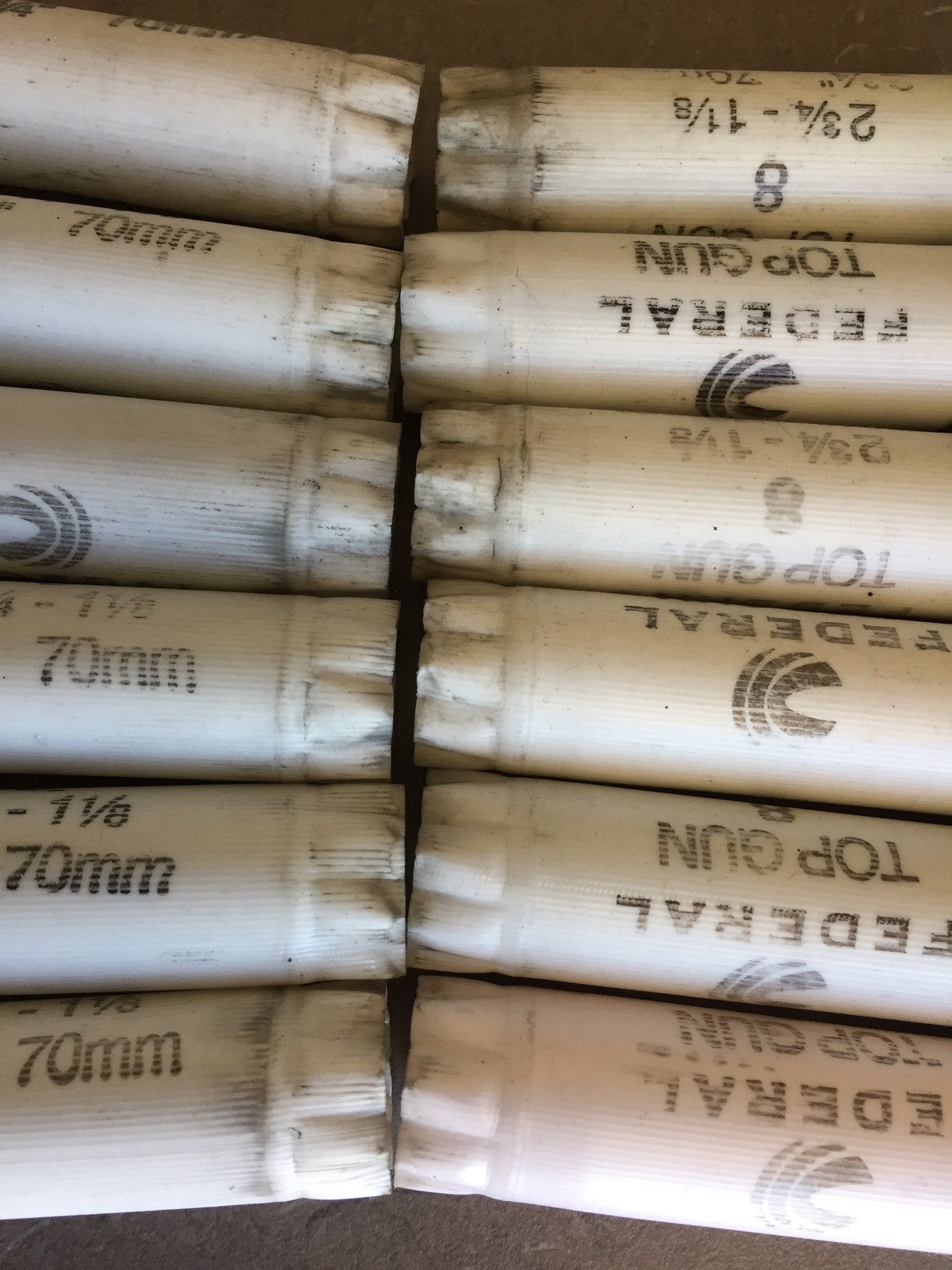 Two rows of white Federal Top Gun shotgun shells showing 2 3/4 - 1 1/8 70mm markings