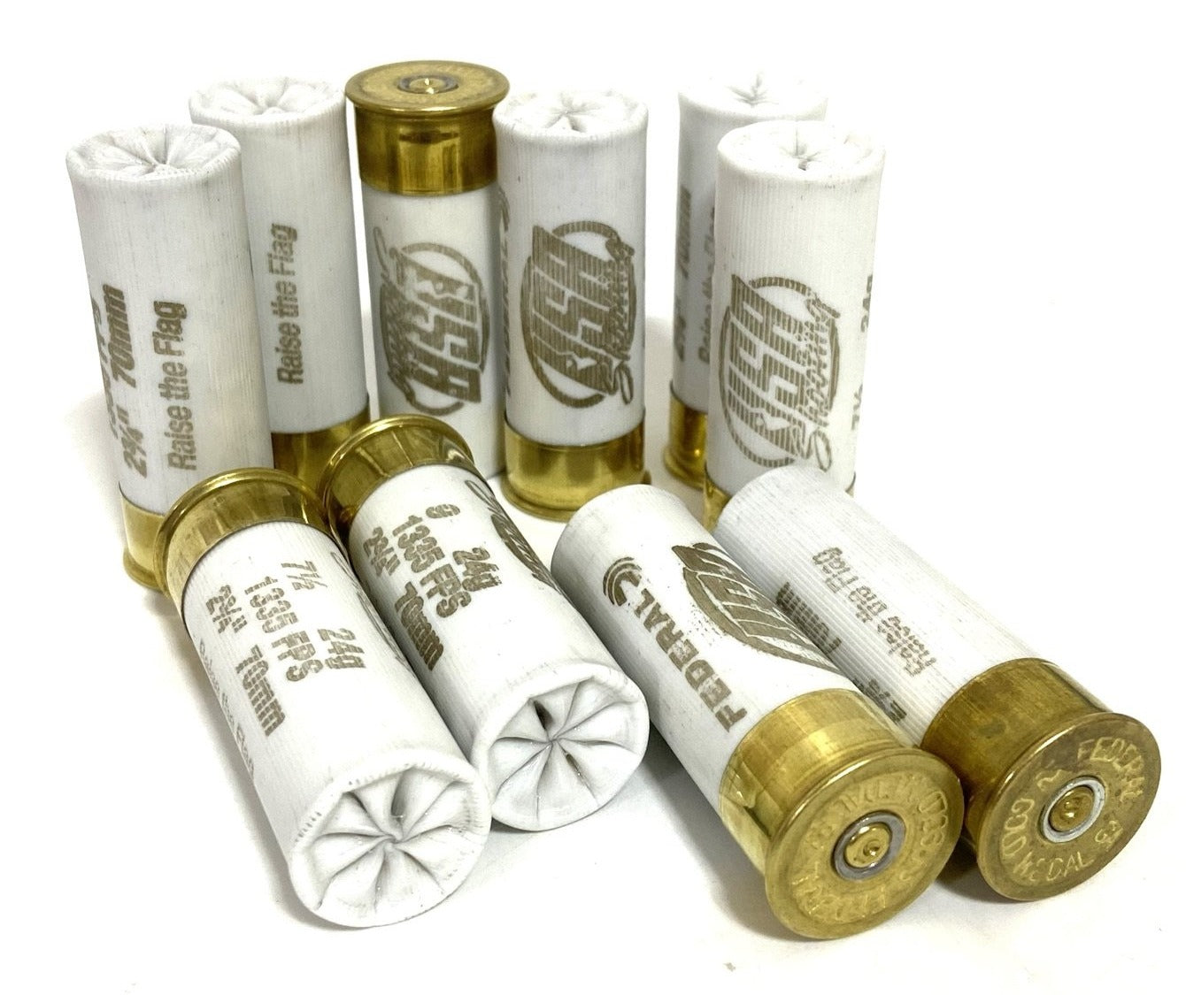 White spent dummy rounds grouped together, some upright and some on their sides, showing Federal and USA Shooting markings.