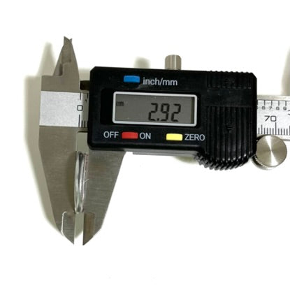 Digital caliper measuring the thickness of a Winchester shotgun shell slice showing 2.92 mm