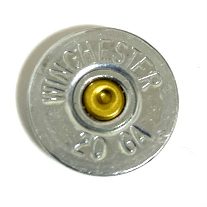 Close-up of a silver Winchester 20 gauge shotgun shell slice showing a brass primer