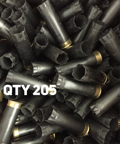 Heap of spent gray Winchester AA 12 gauge shotgun shells with brass bases and bold white QTY 205 text overlay.