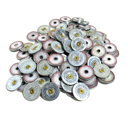 Large pile of silver Winchester 12 gauge shotgun shell slices with brass primers