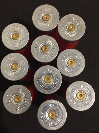 Nine red Winchester 12 gauge shotgun shells viewed from above showing silver headstamps