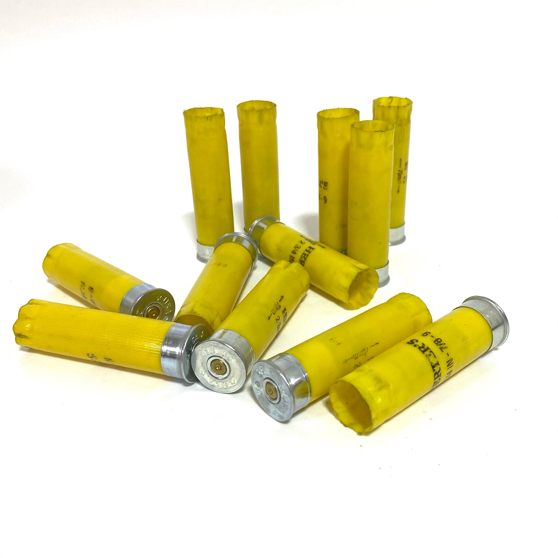Mixed pile of used Herter's 20 gauge yellow empty shotgun shell hulls
