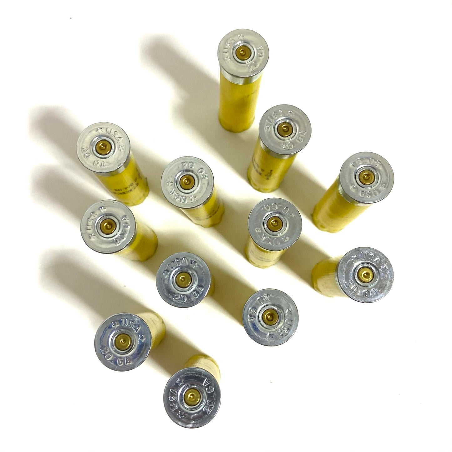 Close-up of silver headstamps on Herter's 20 gauge yellow shotgun shells