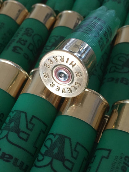 Close-up of a gold shotgun shell base embossed "Clever Mirage" surrounded by green shells printed "SAT magic"
